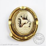 A Victorian carved ivory 'swivel' memorial brooch, depicting dogs in a woodland setting,