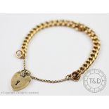 An 18ct yellow gold bracelet with attached 9ct gold padlock clasp, attached safety chain,