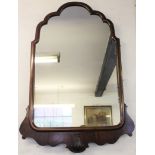 A Queen Anne style walnut wall mirror, of shaped form, with shell detailing,