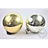 A late 19th/ early 20th century silver glass witches ball and another similar gold glass example,