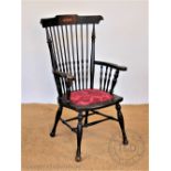 A late 19th century American stained beech spindle back chair, with upholstered seat,