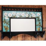 An Aesthetic ebonised wall mirror, with five section tile surround hand painted with anemones,