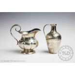 A 19th century Russian silver milk jug of compressed lobed form with scroll handle, 10.
