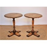 A pair of modern light oak circular occasional tables, with turned columns,