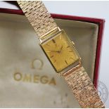 A 18ct gold Omega wristwatch, the rectangular case enclosing gilt face with batons,