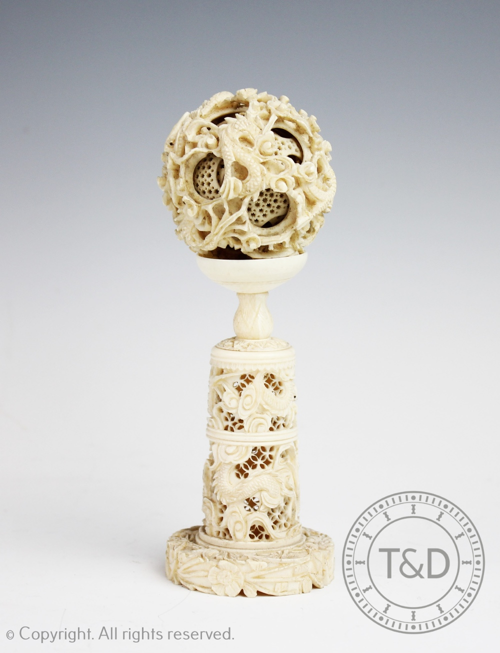 A late 19th century Chinese Canton carved ivory puzzle ball and stand,