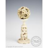 A late 19th century Chinese Canton carved ivory puzzle ball and stand,