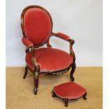 A Victorian carved walnut show frame salon chair on cabriole legs,