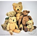 Five assorted early 20th century and later teddy bears to include a large straw filled golden plush
