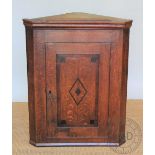 A late George III oak corner cabinet, 92cm H x 72cm W, with a bentwood French cafe style chair,