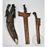 A Kukri knife with karda and chakmak within sheath with a Kriss knife with wrought iron blade and