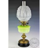 A Victorian oil lamp with green opaque glass reservoir,