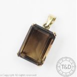 A smokey quartz set pendant,