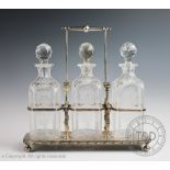 A late Victorian silver plated Tantalus in the manner of Christopher Dresser,
