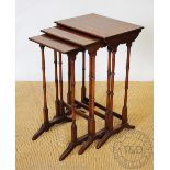 An Edwardian mahogany triple nest of tables, with box wood line inlaid tops, on turned legs,