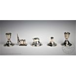 A selection of silver comprising, a pair of short candlesticks, Hampton Utilities, Birmingham 1977,