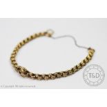 A yellow metal bracelet, designed as Belcher type links with a central entwined knot detail,