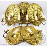 A set of five 17th century style Dutch wall sconces, embossed with cherubs and scrolling foliage,