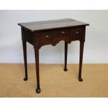 An early 19th century and later oak low boy with three drawers and shaped apron,