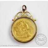 A Victorian gold double sovereign dated 1893 in glazed pendant surround