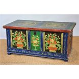 A late 19th century German painted pine marriage chest, decorated with panels of flowers,