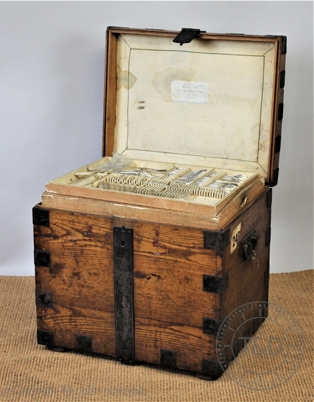 A Victorian golden oak and iron bound silver chest enclosing an assorted silver plated contents