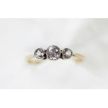 A three stone diamond ring, the three graduated old cut diamonds, each collet set