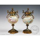 A pair of 19th century French champleve enamel and ormolu mounted porcelain urns,