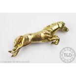 A 9ct yellow gold horse brooch, London 1973, designed as a jumping horse with naturalistic finish,