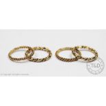 Two pairs of 9ct gold 'keeper' rings, each of twisted design, gross weight 7.