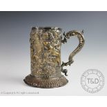 An impressive silver plated mug, 19th century, moulded in relief with mythical sea creatures,