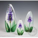 A graduated set of three Swedish Maleras Mats Jonasson glass iris paperweights,
