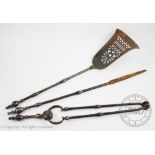 A matched Victorian steel three piece companion set, with pierced shovel and turned finials,
