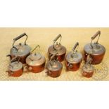 A collection of nine copper kettles, various sizes,