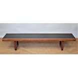 A 1960's long teak coffee table, with black top,