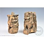 Two carved hardwood Indian or Burmese temple mounts or corbels, each depicting lions,