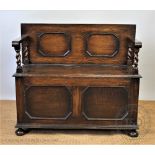 A 1920's oak hall bench / settle, with panelled back,