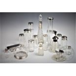 A collection of Victorian and later silver mounted dressing table wares, to include, vanity bottles,