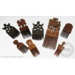 A collection of eight West African tribal art carved wood hair combes,