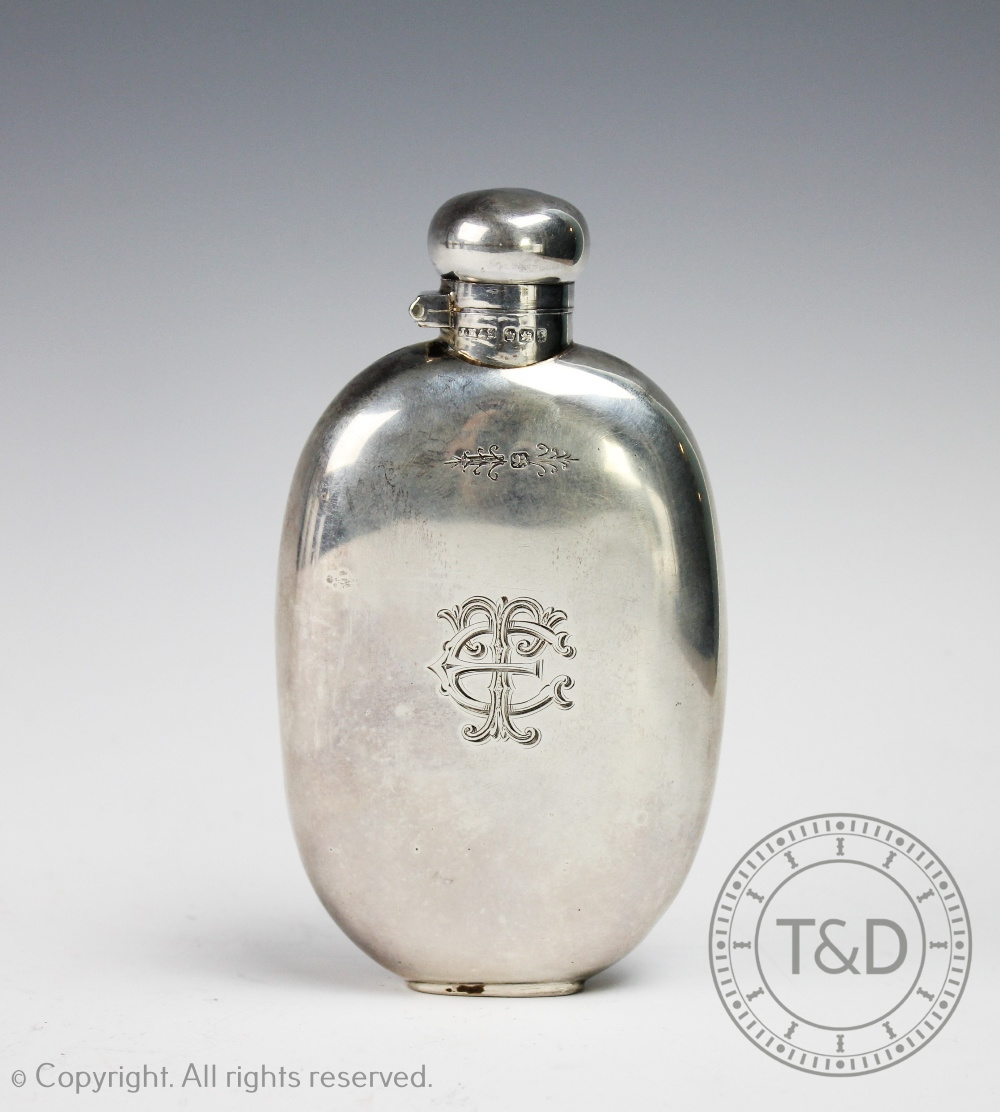 A silver hip flask, 'J M & S' Sheffield 1911, of oval form with concave back and bayonet top,