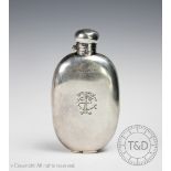 A silver hip flask, 'J M & S' Sheffield 1911, of oval form with concave back and bayonet top,