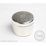 A Russian silver cylindrical dressing table box and cover, the cover engraved with floral sprays,
