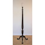An Edwardian carved mahogany standard lamp, with fluted column,