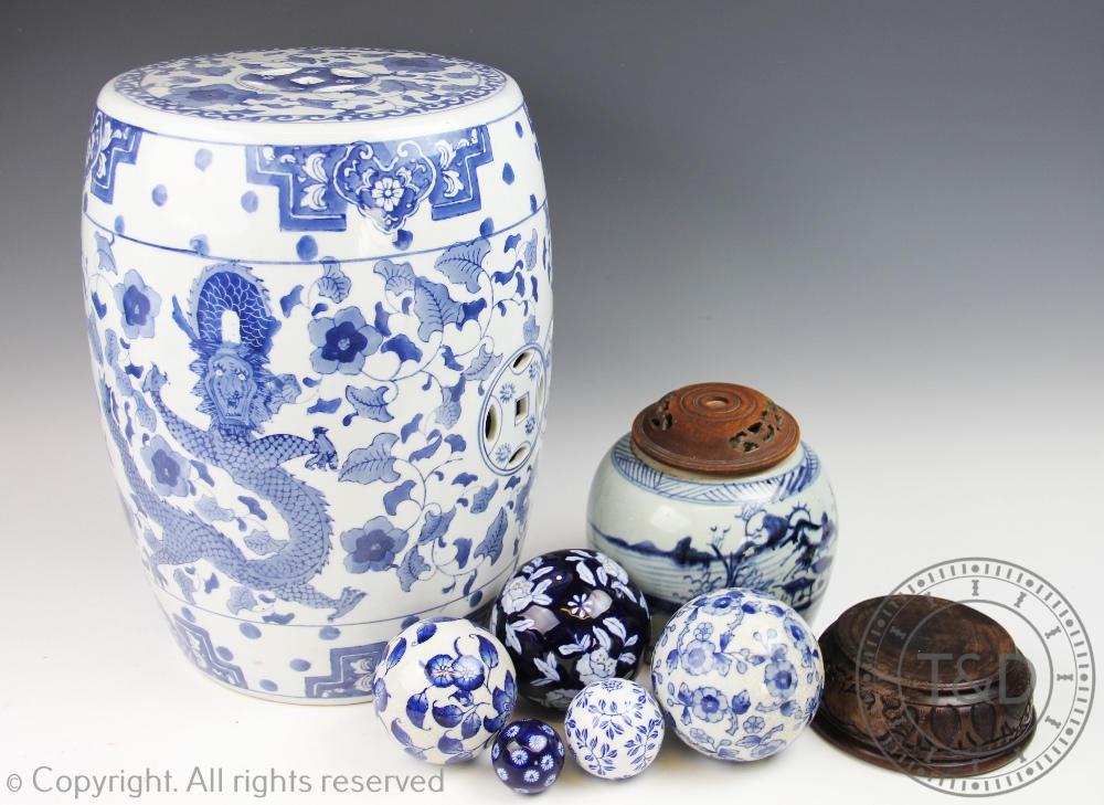 A Chinese blue and white stool of barrel form, decorated with a dragon and phoenix, 37cm high,
