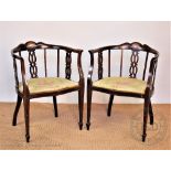 A pair of Edwardian inlaid mahogany tub chairs, on tapered legs,