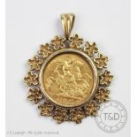 An Edward VII gold half sovereign dated 1910 within later 9ct gold mount with floral border,
