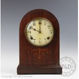 An early 20th American inlaid oak dome top mantel clock, with Arabic dial.