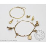 A 9ct gold slender curb link chain with attached charms,