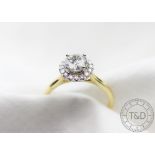 A diamond solitaire 'halo' ring,