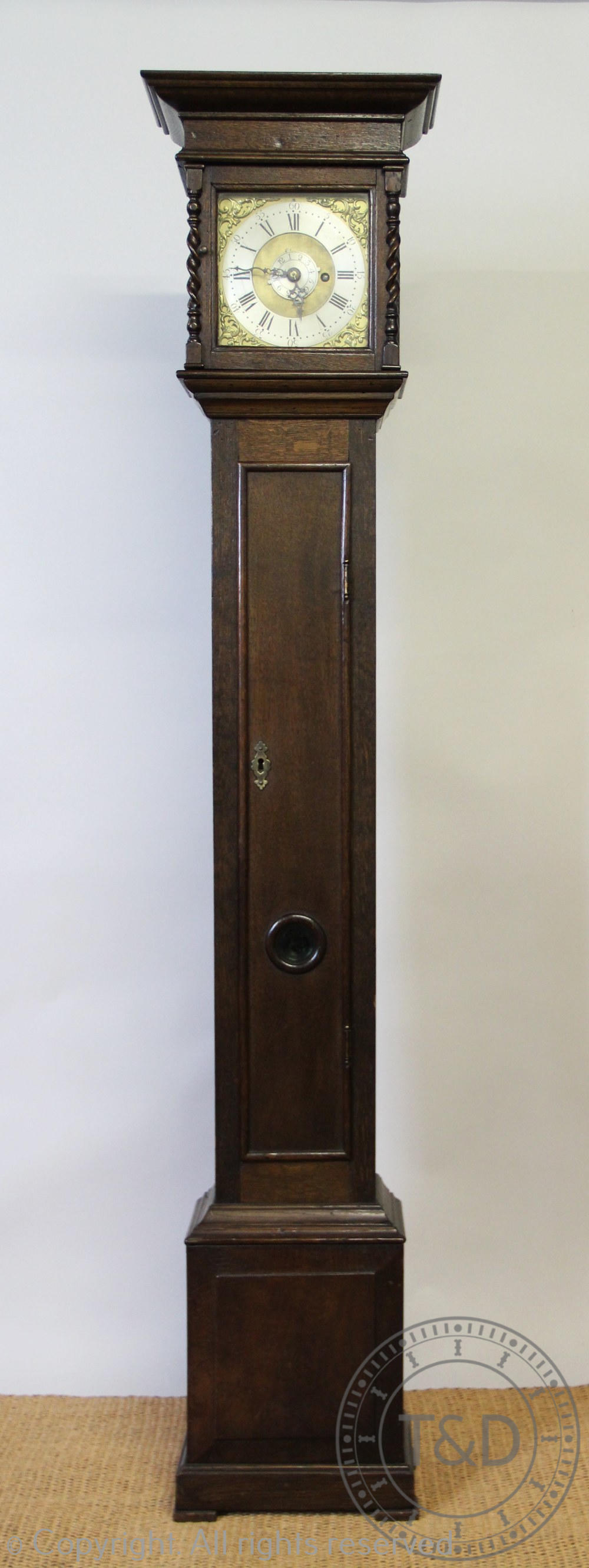 An 18th century style eight day oak Quaker type clock, with Roman numeral chapter ring,